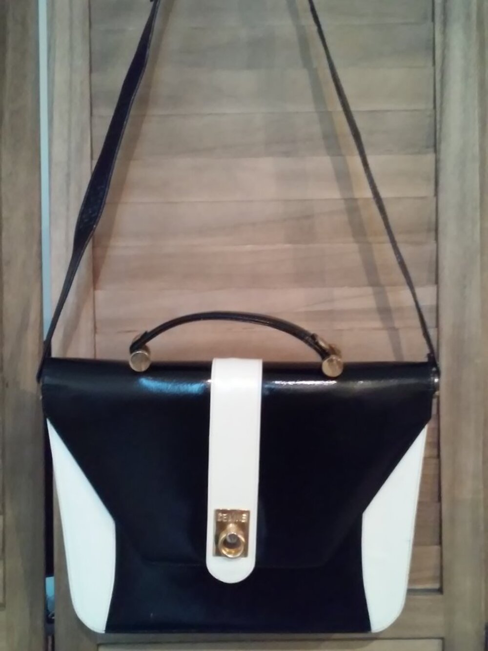 large vintage luxury inspired black and white sturdy bag with gold tone hardware
